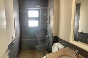 a bathroom with a toilet and a sink and a window at Tawila, 4 Bedroom Villa, Brand new, directly on a lagoon in Hurghada