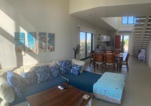 a living room with a blue couch and a table at Tawila, 4 Bedroom Villa, Brand new, directly on a lagoon in Hurghada