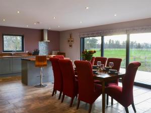 a kitchen and dining room with a table and chairs at Brewers Cottage in Slaley