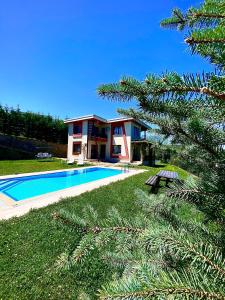 a villa with a swimming pool and a house at Nevras Resort Sapanca in Sapanca