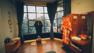 a room with a jacket hanging in a window at Daruma Home in Da Lat