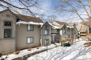 a row of houses in the snow at Luxury Seven Springs Condo- 3 Bed & Loft, 3 Bath in Champion