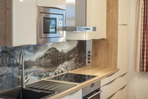 a kitchen with a sink and a stove top oven at Haus Klaffenböck in Bad Gastein