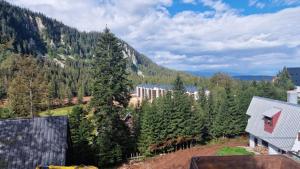 a view of a mountain with trees and a building at Apartman Dream Jahorina Snjezna Dolina in Jahorina
