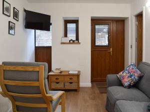 a living room with a couch and a chair at Chunal Apartment - Uk12958 in Glossop