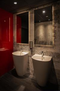 a bathroom with two sinks and a large mirror at Abton Hotel in Łódź