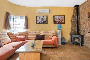 a living room with a couch and a wood stove at Villa Giovanni in Barbate