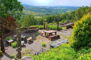 a picnic table and benches in a garden with a view at Wastwater Cottage on The Big "W" Ranch in Nether Wasdale