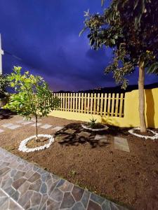 a fence with two trees in a yard at Casa Rebeca in Teror