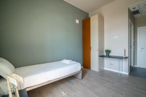 a bedroom with a bed and a dresser at Casa a Colori Padova in Padova