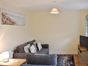 a living room with a couch and a table at Drake Lodge in Staithes