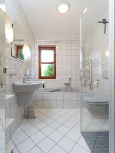 a bathroom with a sink and a shower and a tub at Ferienwohnung Auszeit in Losheim