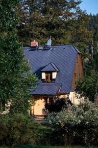 マラー・モラーヴカにあるPenzion pod Strániの窓付きの黒屋根の家