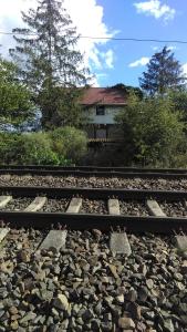 a pair of train tracks with a house in the background at Altes Bahnerhaus 