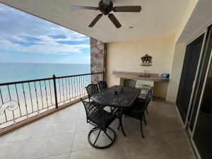 a balcony with a table and chairs and the ocean at Sonoran Sky in Puerto Peñasco