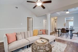 a living room with a couch and a table at The Masters Cottage by Augusta National in Augusta