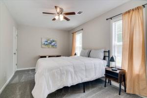 a bedroom with a bed and a ceiling fan at The Masters Cottage by Augusta National in Augusta