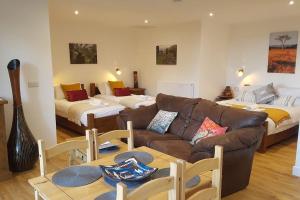 a living room with a couch and two beds at Wastwater Cottage for Scafell and Wasdale in Seascale