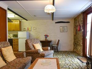 a living room with a couch and chairs and a table at Lower Chinkwell-uk12426 in Widecombe in the Moor