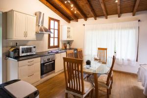 a kitchen with a table and a dining room at La Huerta, megustarural in Llanes +28 photos