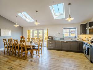 a kitchen and dining room with a table and chairs at Cor Tarw - Uk12743 in Acrefair