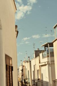 a row of white buildings on a city street at Beans Street Affittacamere in Mola di Bari