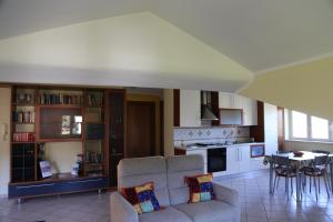 a living room with a couch and a table and a kitchen at La Masseria PietraMarmo Caiazzo - App to con vista in Caiazzo +43 photos