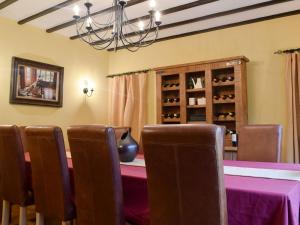 a dining room with a table and chairs and a chandelier at Springfields in Leek