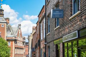 a city street with buildings and a sign for the amennes at The Lawrance Luxury Aparthotel - York in York