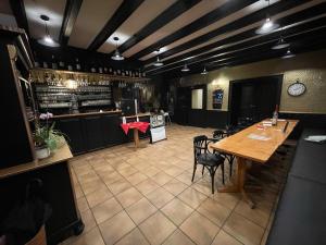 a restaurant with a table and chairs and a bar at Cici Monteurunterkünfte Plettenberg Oestertal in Plettenberg