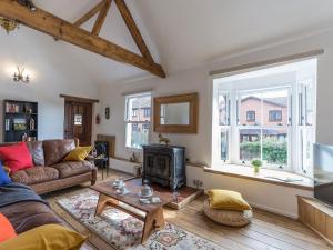 a living room with a couch and a fireplace at The Old Rope Works in Bewdley