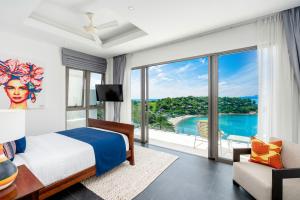 a bedroom with a bed and a large window at Samui Bayside Luxury Villas in Choeng Mon Beach