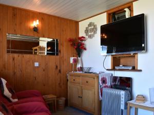 a living room with a flat screen tv on the wall at Poppy Lodge in Kingsdown