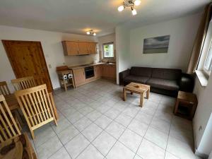 a living room with a couch and a table at Chico in Graal-Müritz +5 photos