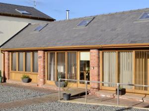 a extension to a house with a roof at Little Hendre Lodge - Uk10262 in Penrhôs