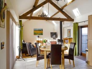 a dining room with a table and chairs at Little Hendre Lodge - Uk10262 in Penrhôs