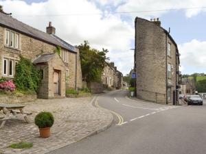 an empty street in a village with at Weavers Houses in Hayfield