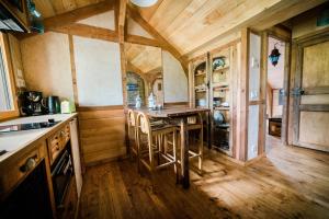 a kitchen with a table and chairs in a room at Le Moulin d' Erée, gîte Insolite de charme in Soudan