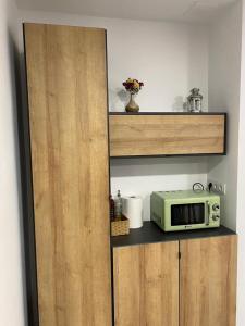 a microwave sitting on a shelf in a kitchen at Apartamento Concarera in Tudela +7 photos
