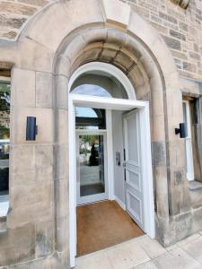 an archway with a white door in a building at Unique Two Bed Holiday Home in Edinburgh in Edinburgh