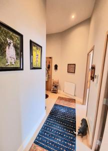 a hallway with a dog picture on the wall at Unique Two Bed Holiday Home in Edinburgh in Edinburgh