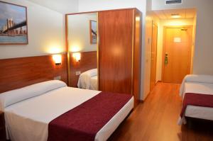Postel nebo postele na pokoji v ubytování Hotel Reus Park
