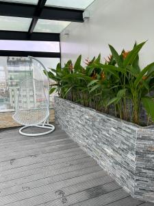 a chair sitting on a balcony with plants at Skylark Hotel in Hanoi