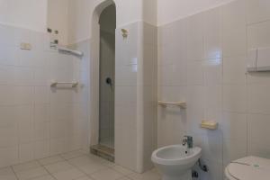 a bathroom with a shower and a toilet and a sink at Portynord in Canneto