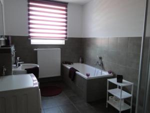 a bathroom with a tub and a toilet and a sink at Fewo Jüterbog City in Jüterbog