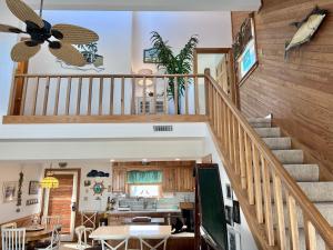 a staircase in a home with a dining room and kitchen at My Three Gulls in Kill Devil Hills