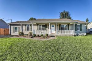 a house with a porch and a yard at Classic Murfreesboro Home with Grill and Yard! in Murfreesboro