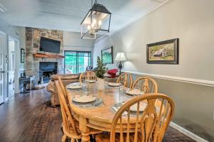 a dining room and living room with a table and chairs at Cozy Gatlinburg Condo about 2 Mi to National Park! in Gatlinburg