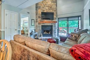 a living room with a couch and a fireplace at Cozy Gatlinburg Condo about 2 Mi to National Park! in Gatlinburg