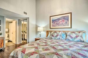 a bedroom with a bed with a quilt on it at Cozy Gatlinburg Condo about 2 Mi to National Park! in Gatlinburg